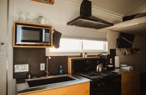 Meeker House | This Tiny Home is custom made by a Colorado craftsman has one Queen bed in loft accessible by stairs and also has a fold out Full futon on main level. Sleeps up to 4. Please note, this home does have a sleeping area in a loft. If you require an accom