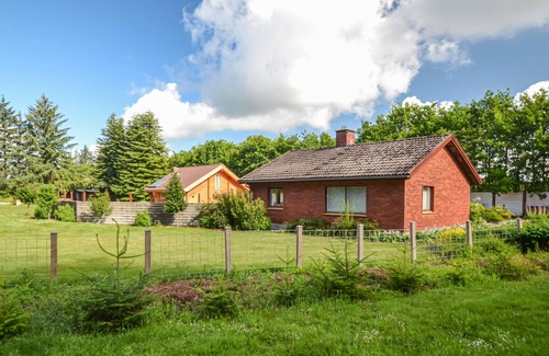 Varde House | This vacation home is located directly in the forest, yet close to the town of Varde.