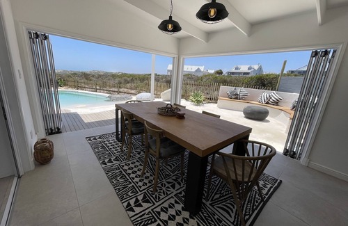 Grotto Bay House | Tranquil haven: home in nature's embrace, where ocean and dunes unite.