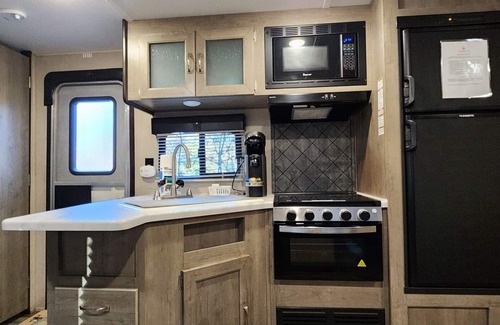 Mill Spring House | Travel trailer near the creek, short walk to pool and playground, indoor and outdoor kitchenette, sleeps 8.