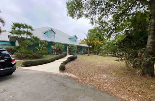 Palm City House | Tropic Retreat! Pool, 3 acres, pond, 4500sq ft