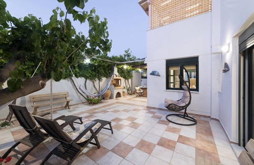 Koutsouras Condo | Two bedroom luxury condo with private patio with vineyard & BBQ near beach