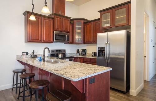 Moab Condo | Unique Stay in Downtown Moab! Master Bedroom Climbing Wall - Elevated Bunks