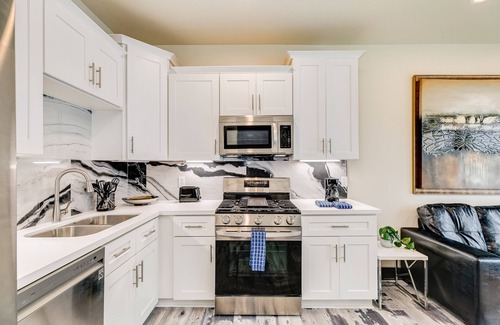 Bacliff House | Vibrant orange retreat with an enclosed yard, grill, and ocean views - dogs ok
