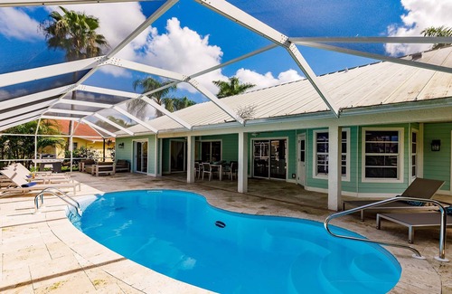 Cape Coral Villa | Villa Coral Cove heated pool, large lanai, lounge and fire pit in For Mile Cove