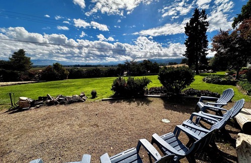 Medford Cottage | Wake to breathtaking sunrises over the rolling hills! Relax by the fire under the stars, & savor sunset dinners beneath fragrant wisteria pergola. Surrounded by wineries and minutes from historic Jacksonville, this retreat blends charm & convenience