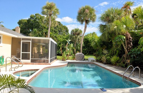 South Beach House | Walk to private beach Heated pool Kayaks bikes quiet tropical back yard