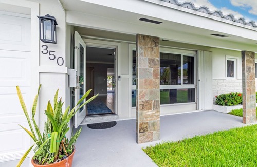 Garden Isles House | Waterfront home with private backyard. Heated pool with waterfall Jacuzzi