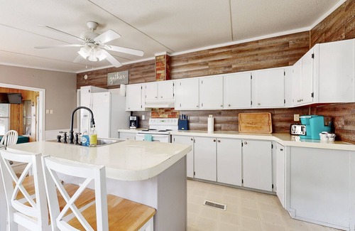 Enchanted Oaks House | Waterfront home with paddleboards, kayaks, grill, firepit, W/D, and jetted tub