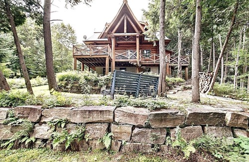 La Minerve Cottage | Waterfront Log Cottage with Hot Tub and Sauna