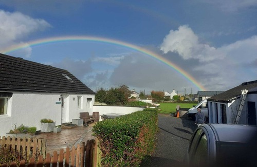 Bryngwran House | Whitewashed 1 bedroom stone cottage, with king size 4 poster bed. Pet friendly.