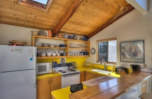 Sea Ranch House | Wide open meadow view with ocean peeks through the trees.
