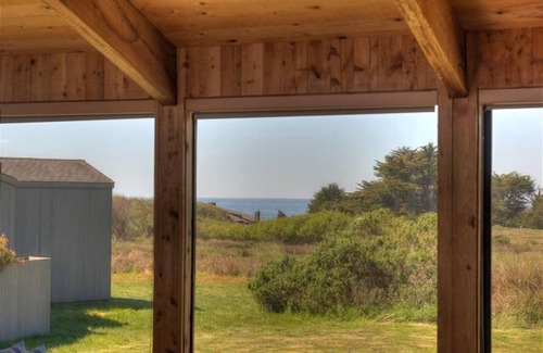 Sea Ranch House | Wide open meadow view with ocean peeks through the trees.