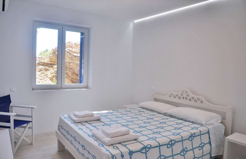 Tinos House | Windmill and houses by the sea / Stavros Bay