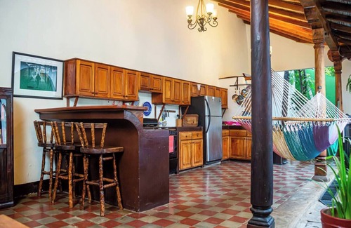 Granada House | You’ll know that you have rented a historic colonial home when you pass through huge, antique front doors framed by 3 foot-thick adobe walls. Lounge on the shallow, submerged bench seats in the pool or in the hammocks hanging between 12 foot wooden c