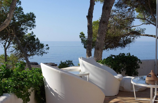A large villa with garden and terraces at the water's edge