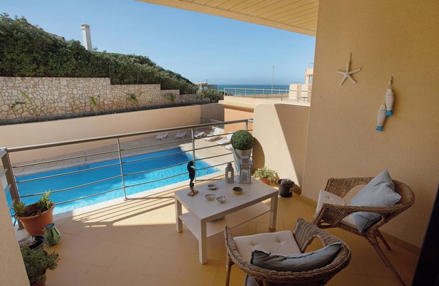 Apartment 'Praia Areia Branca' with Sea View, Shared Pool and Wi-Fi