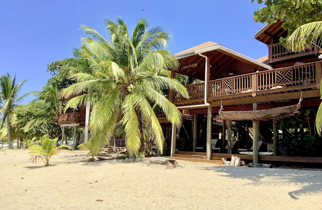 Beachfront home with pristine, calm waters, white sands and unbelievable sunset