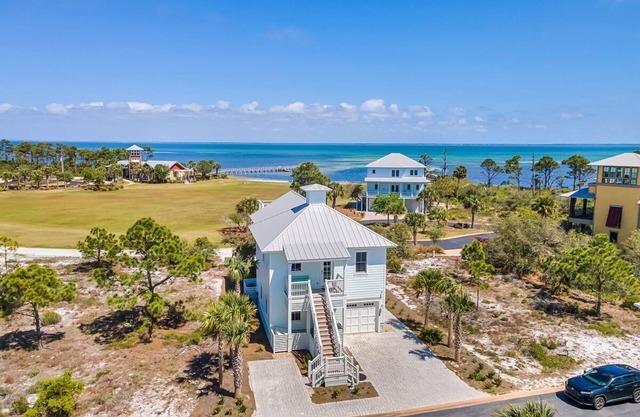 Charming bayside home in a gated community with beach gear, pools, and a hot tub—your perfect coastal getaway!
