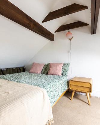 En-suite with double bed on mezzanine and desk in family home
