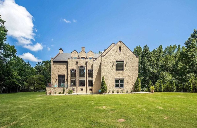 Enchanted Manor: A Luxurious Tudor-Style Retreat Amidst Nature's Splendor