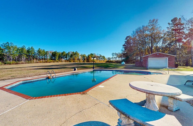 Expansive property with two homes, ponds, pool, game tables, & hiking trails