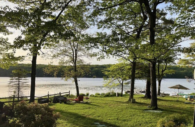 Glacial lake on top of mountain, boats, floating dock, fishing, swimming, beach.