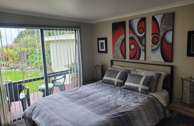 Great room with lovely view of the garden and beyond that Golden Bay