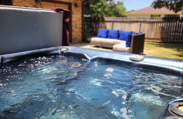 Large home sleeps 15, close to campus with hot tub and more!