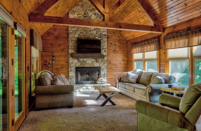 Log Cabin with living room fireplace and hot tub