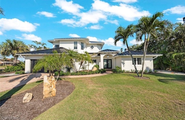 Modern luxury house with ensuite bedrooms, deepwater canal access, and pool.