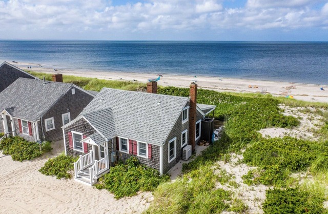 Ocean front oasis nestled into the dune on a private East Sandwich beach.