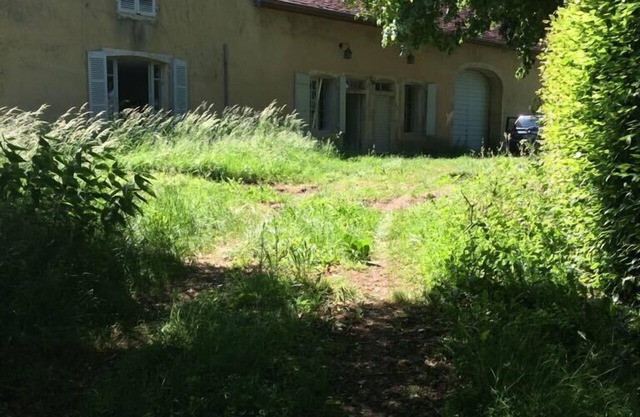 Old house on a medieval mound in the heart of a village in Val d'Amour