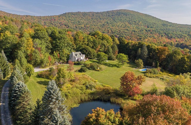 Private Contemporary Cottage with heated pool, hot tub and wide mountain views.