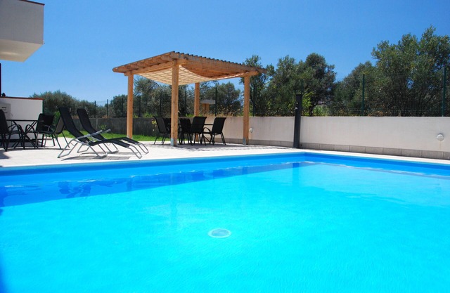 Private gated Villa sleeps 12. Large pool & garden, AC ,WiFi close to the beach.