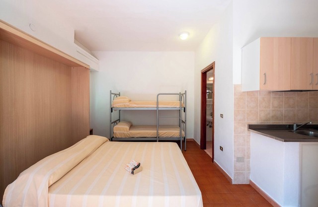 Property In A Holiday Village 'Monolocale Con Giardino' with Shared Pool and Air Conditioning