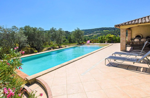 Rustic holiday home with large, shared pool and mountain views, in a charming location.