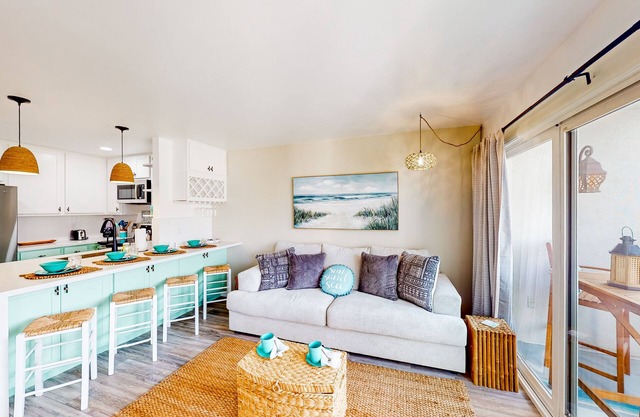 Sound view condo with modern interior, gas fireplace, balcony, & W/D access