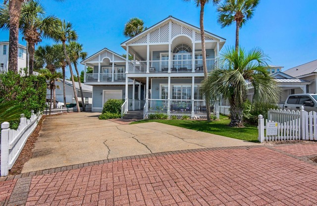 Spacious beach house steps to the powdery white side and emerald water.