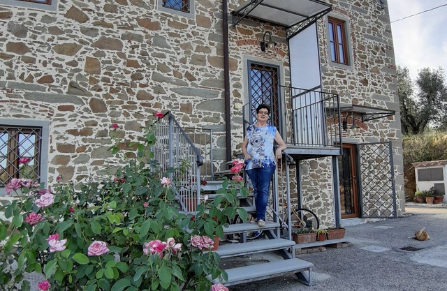 stone farmhouse immersed in an olive grove owned