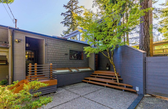 Stunning lakefront home with a private dock, balcony, grill, & a hot tub