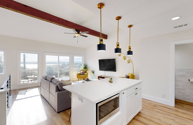 Sunlit condo with water view, furnished balcony, washer/dryer, & central AC