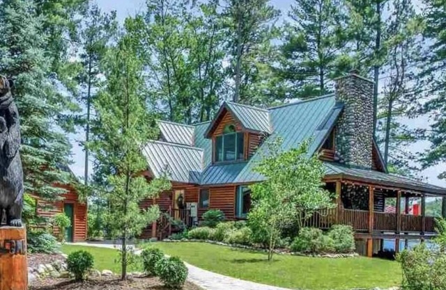 Unique log cedar family vacation home with 185 feet of secluded lake frontage