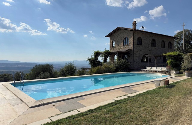 Villa and pool, next to typical Tuscan vineyards and olive groves, breathtaking sunsets