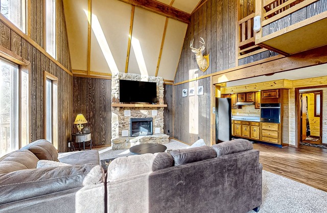 Wooded acreage with wrap-around deck, hot tub, central AC, & game room