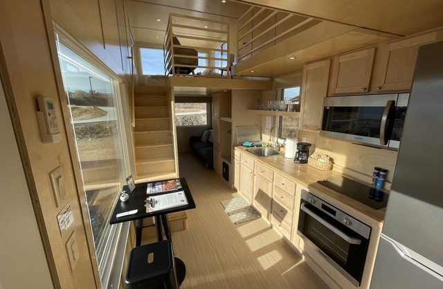 XL tiny home with two lofted queen beds and full size futon on the main level.