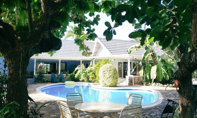 Runaway Bay Villa | Beautiful garden villa. Family friendly. Just a short walk to a private beach.