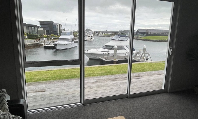 One Tree Point House | Brand new canal-front holiday home, stunning water views, private boat ramp.