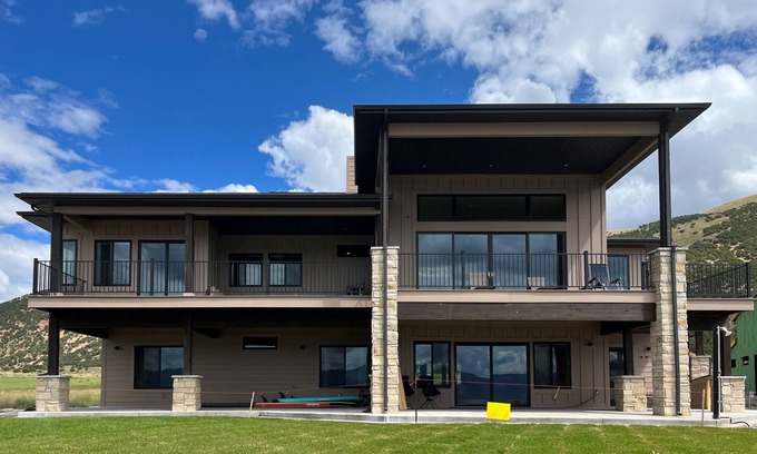 Laketown House | Brand-new lakefront home with private beach, mountain views, fireplace & deck