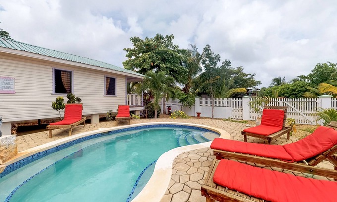 Hopkins Apartment | Cabana with a porch, hammock, & view of the pool & grilling area